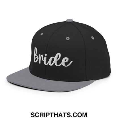 Black and gray snapback hat with bride embroidered in white script and a flat bill brim design