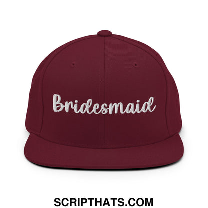 Maroon snapback hat with white embroidered bridesmaid script and flat bill brim for bridal party wear