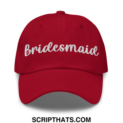 Red unstructured dad hat with white embroidered bridesmaid script across the front for wedding party use