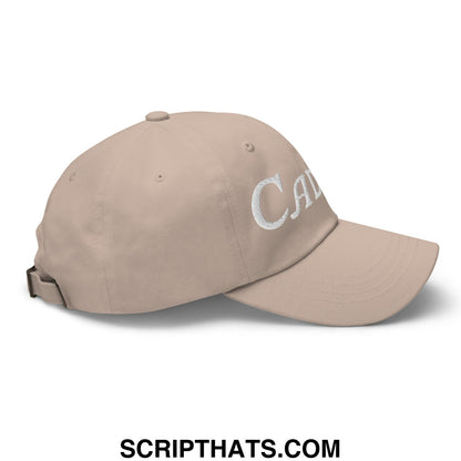 Beige unstructured golf dad hat with white embroidered caddie script lettering ideal for outdoor use