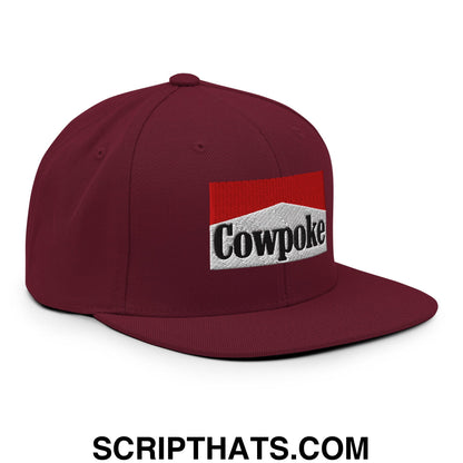 Maroon snapback hat with flat bill brim featuring an embroidered cowpoke logo in red and white rectangular design