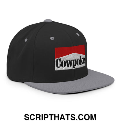 Black and gray snapback cap with red white and black embroidered cowpoke logo and flat bill brim