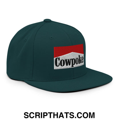 Dark green snapback cap with flat bill brim features embroidered cowpoke logo inspired by marlboro cigarette pack design