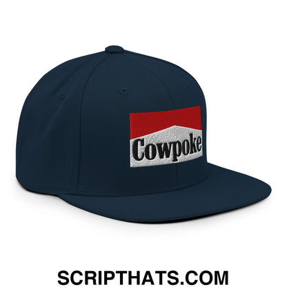 Navy blue snapback cap with embroidered cowpoke logo in red and white featuring a flat bill brim design