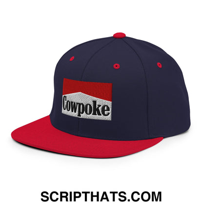 Navy blue and red snapback hat with white embroidered cowpoke logo and flat bill brim for casual wear