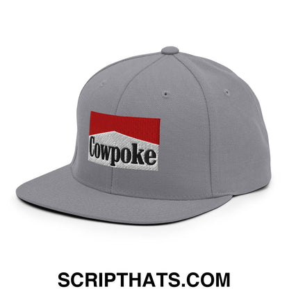 Gray snapback cap with a flat bill featuring a red and white embroidered cowpoke logo with black lettering