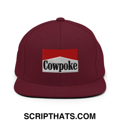 Maroon snapback hat featuring an embroidered cowpoke logo with red and silver design and flat bill brim