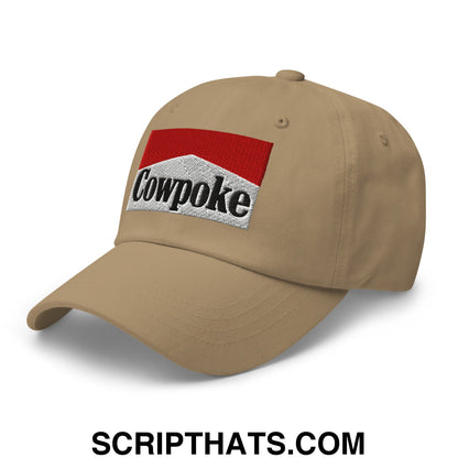 Tan cowpoke embroidered unstructured dad hat featuring a red and silver patch with black lettering on the front