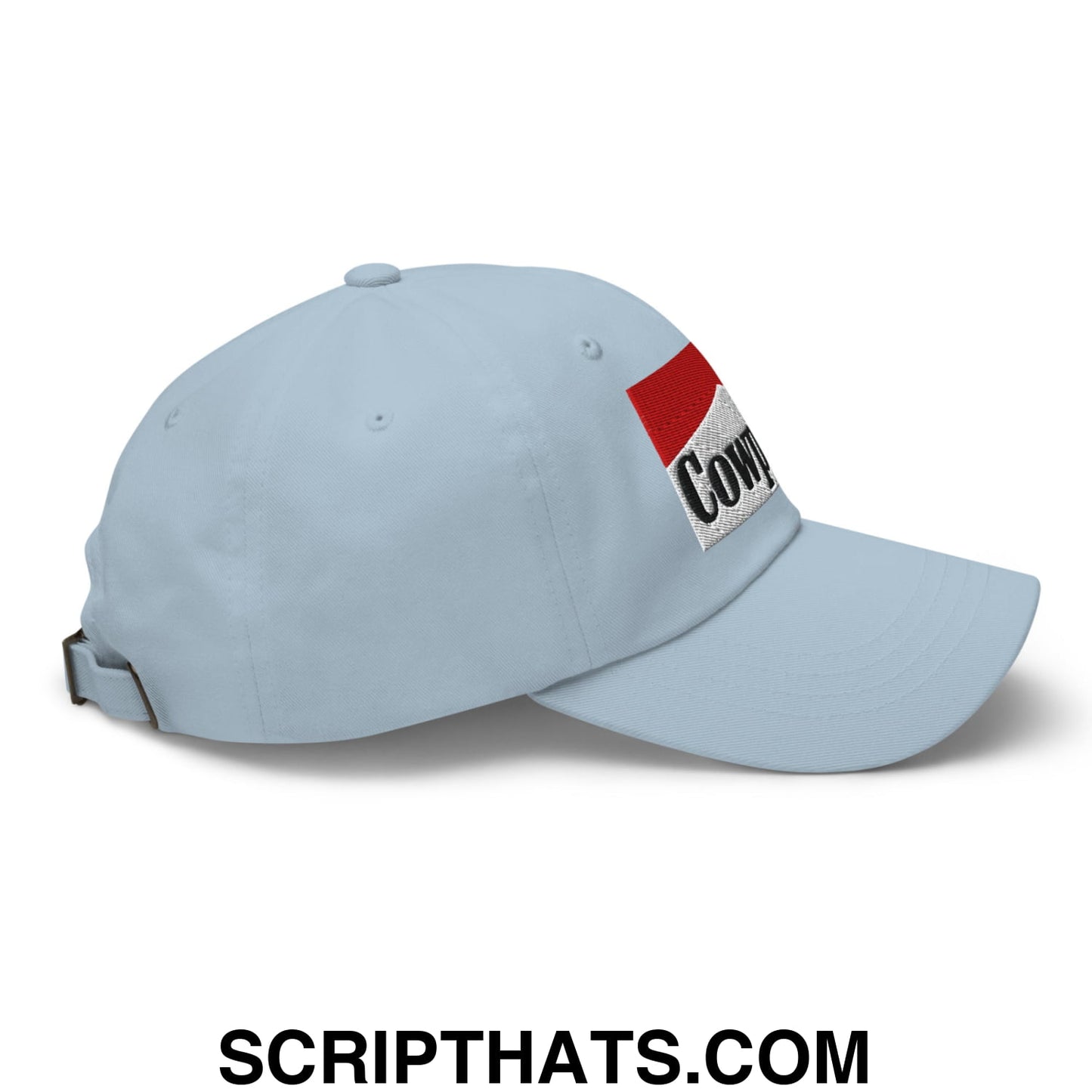 Light blue cowpoke embroidered unstructured dad hat with red and white patch featuring cow in black lettering