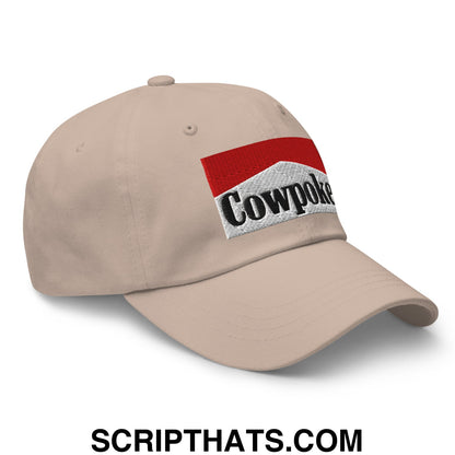 Beige unstructured dad hat featuring an embroidered cowpoke logo with red and white striped design