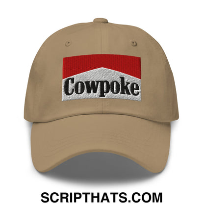 Beige unstructured dad hat featuring an embroidered cowpoke logo with red and silver design on the front