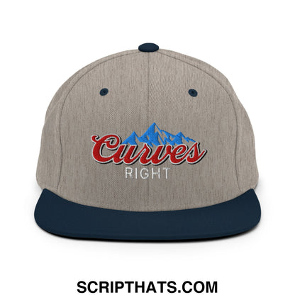 Beige and navy blue snapback cap with embroidered curves right red script logo over a blue mountain design