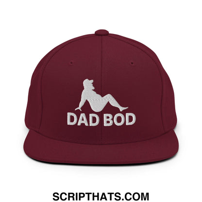 Maroon snapback hat with white embroidered dad bod text and mud flap silhouette flat bill brim design