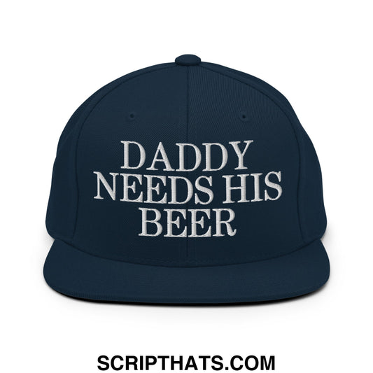 Navy blue snapback hat with white embroidered daddy needs his beer text and flat bill brim design