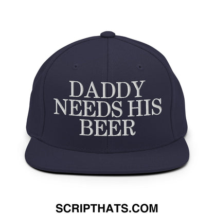 Navy blue snapback hat with white embroidered daddy needs his beer text and flat bill brim design