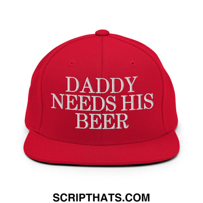Red snapback cap with white embroidered daddy needs his beer text featuring a flat bill brim design