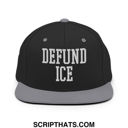 Black snapback cap with gray brim and white embroidered defund ice text in bold collegiate font