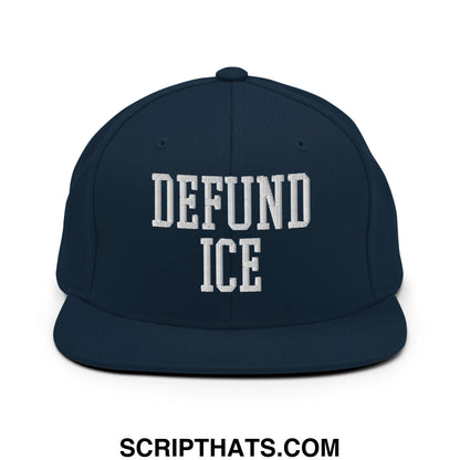 Navy blue snapback hat with white embroidered defund ice text in bold block font and a flat bill brim