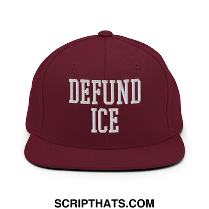 Maroon flat bill snapback hat with white embroidered defund ice text featuring adjustable strap closure