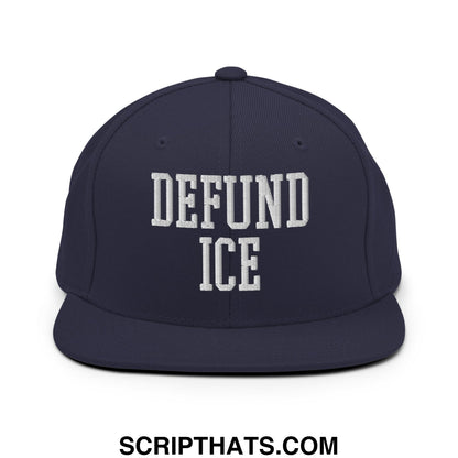 Navy blue snapback hat with white embroidered defund ice text in bold collegiate-style font flat bill brim
