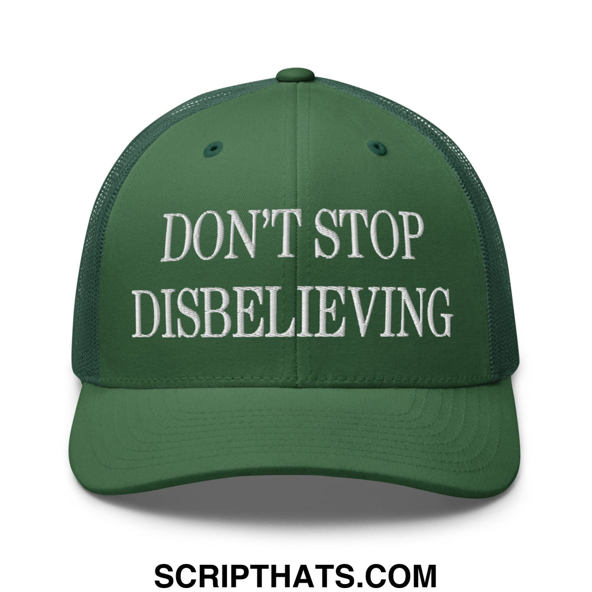 A dark green mesh trucker hat with white embroidered dont stop disbelieving text across the front panel