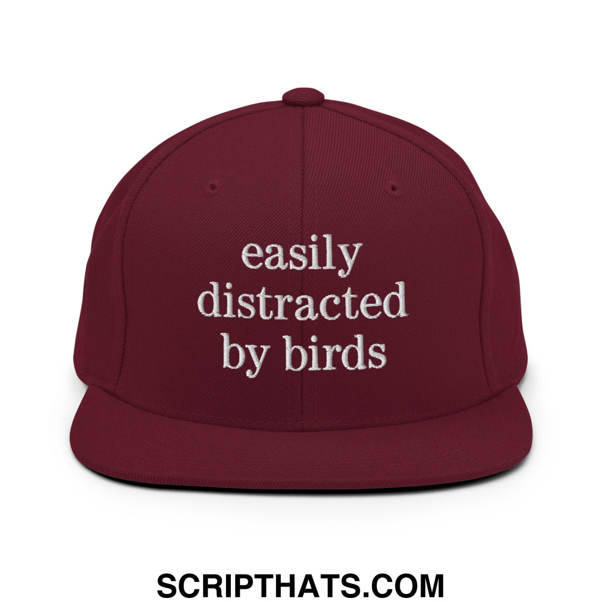 Maroon snapback hat with white embroidered easily distracted by birds text on a flat bill brim design