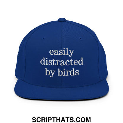 Royal blue snapback hat with white embroidered easily distracted by birds text and flat bill brim design