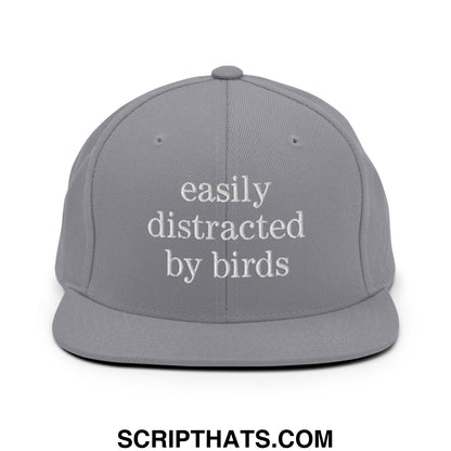 Gray snapback hat with easily distracted by birds white embroidered text and flat bill brim for casual wear