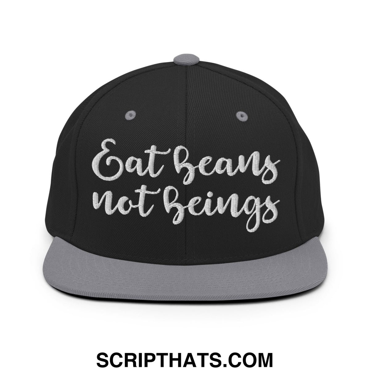 Black snapback cap with gray brim and button featuring white embroidered eat beans not beings text in cursive script