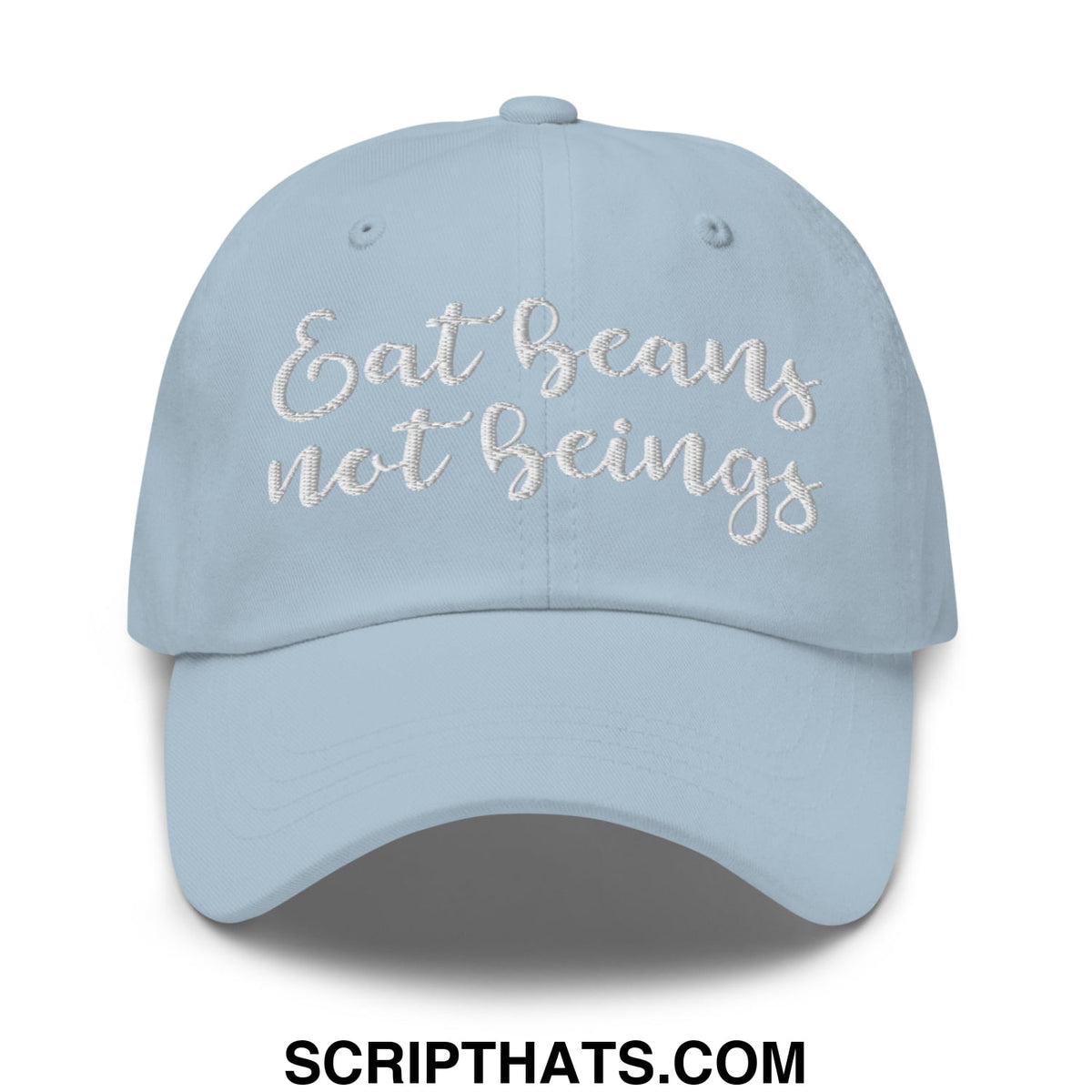 A light blue embroidered unstructured dad hat with the phrase eat beans not beings in white cursive thread