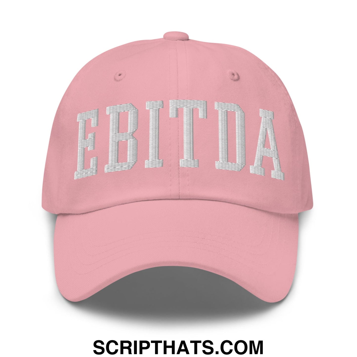 A soft pink unstructured dad hat with ebitda embroidered in white textured arch design