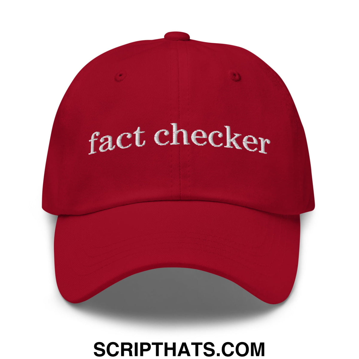 Red unstructured dad hat with white embroidered fact checker text perfect for casual wear