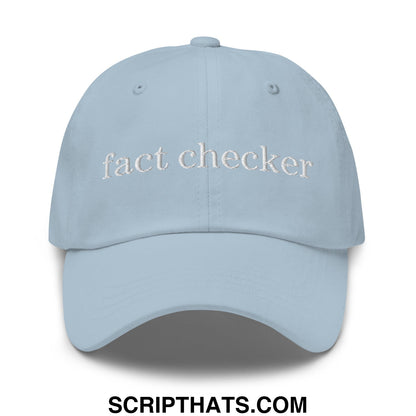 Light blue unstructured dad hat with white embroidered fact checker text for casual wear