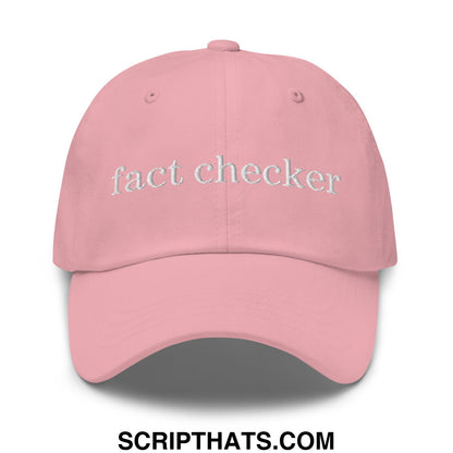 A soft pink fact checker embroidered unstructured dad hat with white thread lettering across the front panel