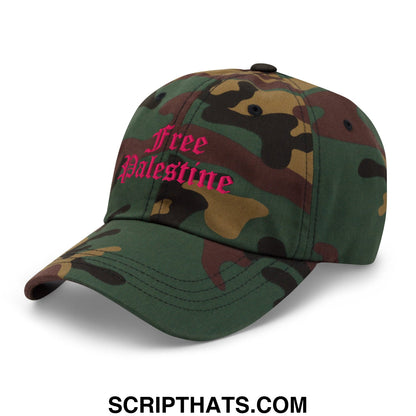 A camouflage unstructured dad hat with free palestine embroidered in pink script on the front panel