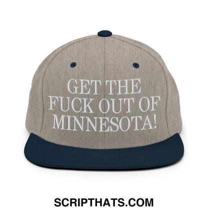 A gray and navy blue snapback hat with white embroidered text get the fuck out of Minnesota flat bill brim