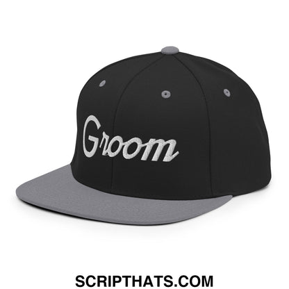 Black and gray snapback hat with groom embroidered in white script on a flat bill brim for sports use