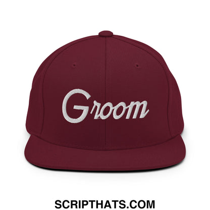 Maroon snapback hat with white groom script embroidery and flat bill brim for sports and casual wear