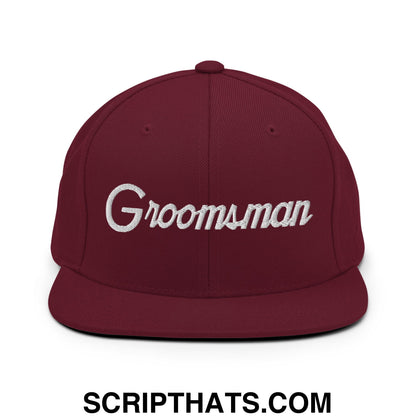 Maroon groomsman snapback hat with white embroidered sports script and flat bill brim for wedding party use