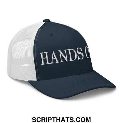 Navy blue and white mesh trucker hat with hands off embroidered in silver thread on the front panel