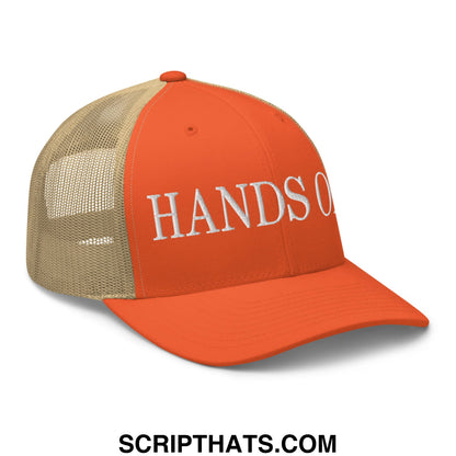 Orange and tan mesh trucker hat with white embroidered hands off text in a breathable design