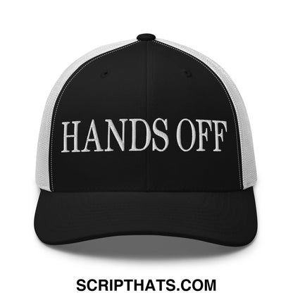 Black and white mesh trucker hat with hands off embroidered in bold stitched letters on the front panel
