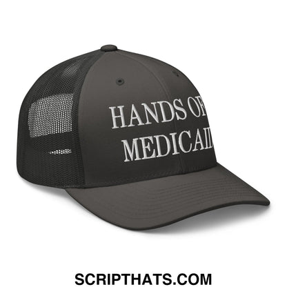 Black mesh trucker hat with white hands of medical embroidered text on front for hands off medicaid design