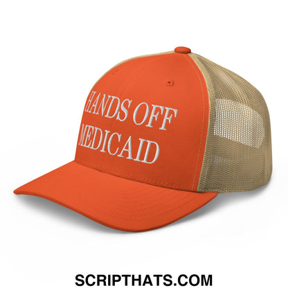 Orange and beige mesh trucker hat with white embroidered hands off Medicaid text for casual wear