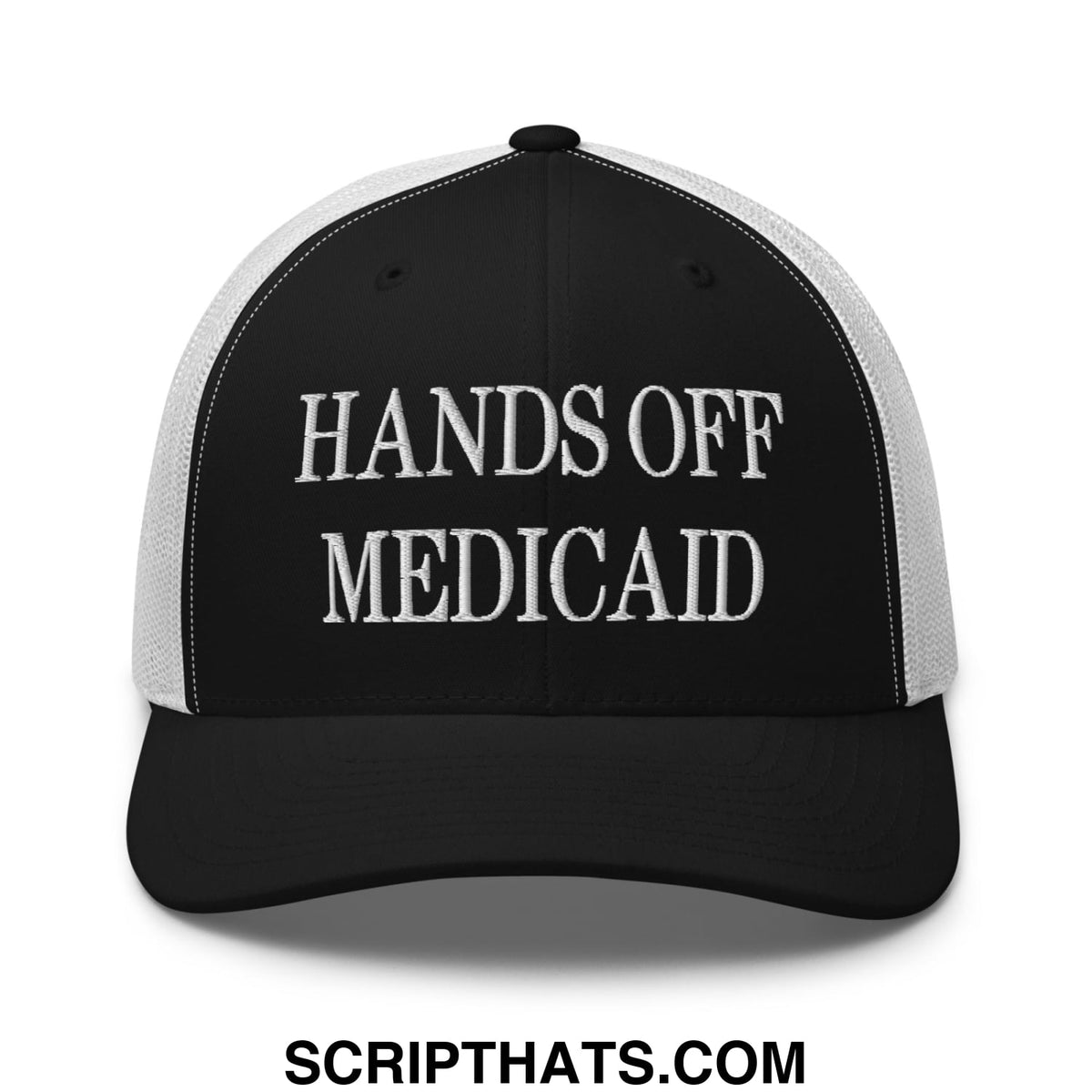 Black and white mesh trucker hat with hands off medicaid embroidered in bold raised white lettering on front