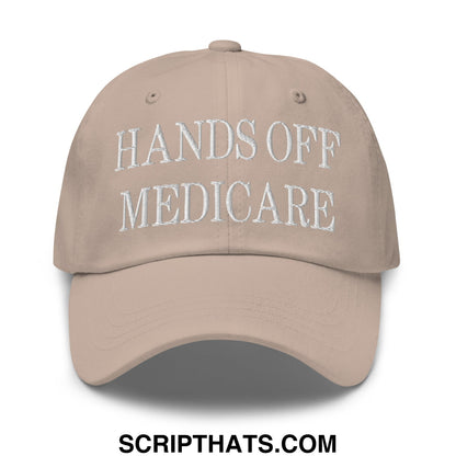 Beige unstructured dad hat with white embroidered hands off medicare text on front panel