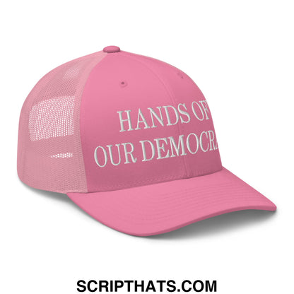Pink mesh trucker hat with white embroidered hands of our democracy text on the front panel