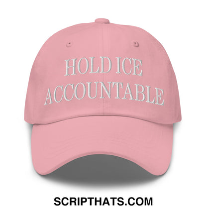 A soft pink unstructured dad hat with hold ice accountable embroidered in white thread across the front