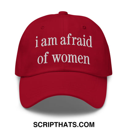 A red embroidered unstructured dad hat with white text reading i am afraid of women for casual wear