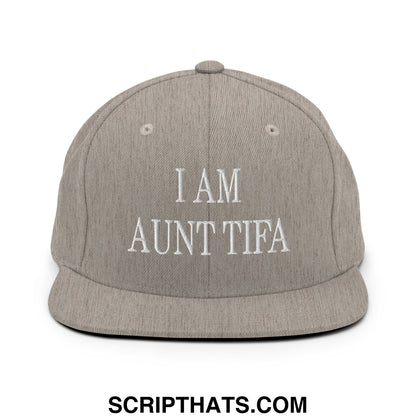 Gray snapback hat with white embroidered i am aunt tifa text and flat bill brim design